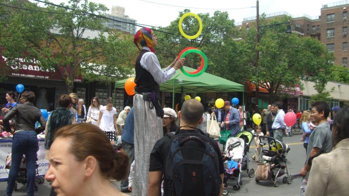 Send In the Clowns! - Street Performer Adam Auslander juggles on stilts at our Block Festival!